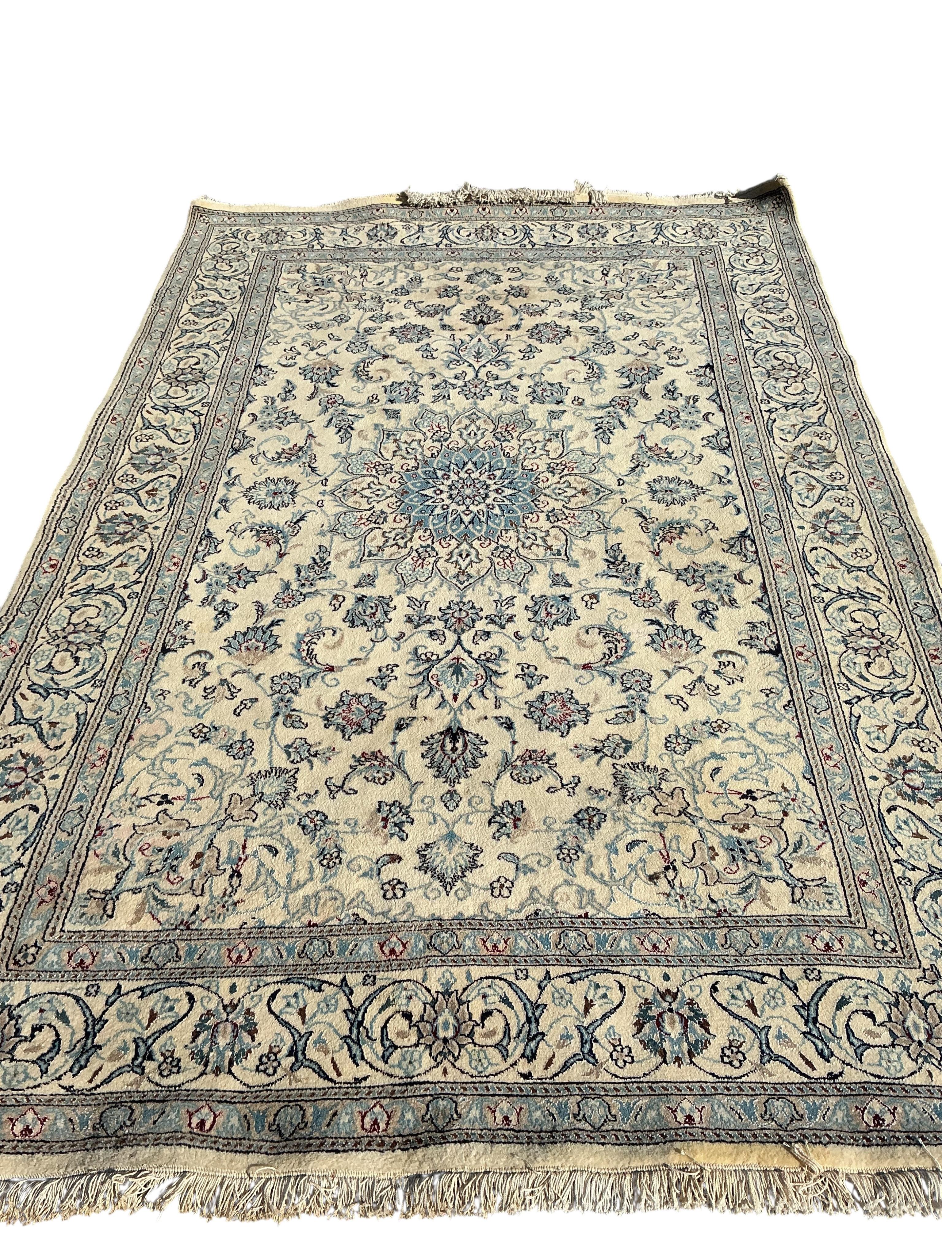 A Tabriz ivory ground carpet, 310 x 195cm